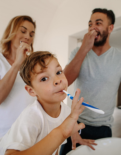 A family brushing and flossing their teeth together